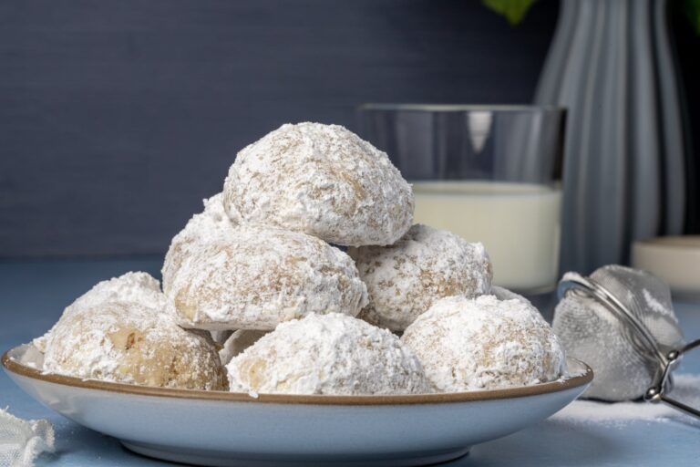 close up shot of kourabiedes on a ceramic plate